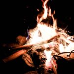 Guests enjoying outdoor barbecue around a bonfire at Shola Crown Resort — premium bonfire facilities in Munnar Kerala.