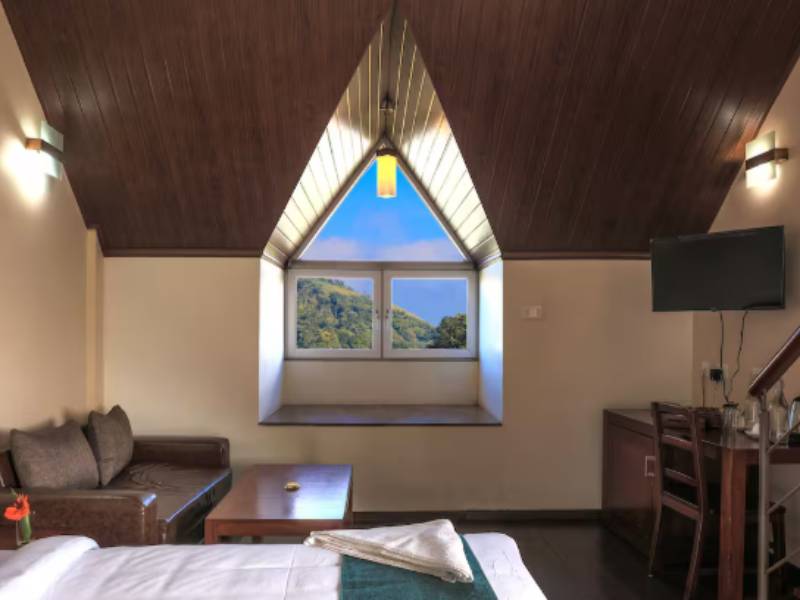 Spacious luxury suite at Shola Crown with plush bedding and panoramic views.