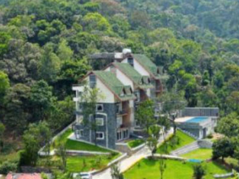 Scenic route view showcasing the Kochi Airport to Shola Crown Fare travel experience through lush Kerala forests